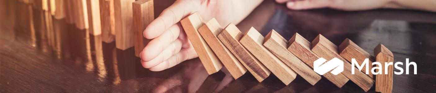 hand blocking cascading wooden blocks from falling
